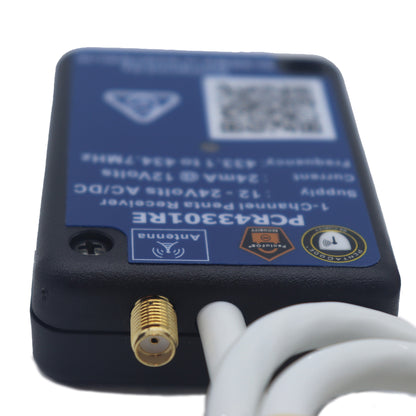 A black electronic receiver device with a blue label, featuring a gold Antenna connector and white cables, shown on a white background.